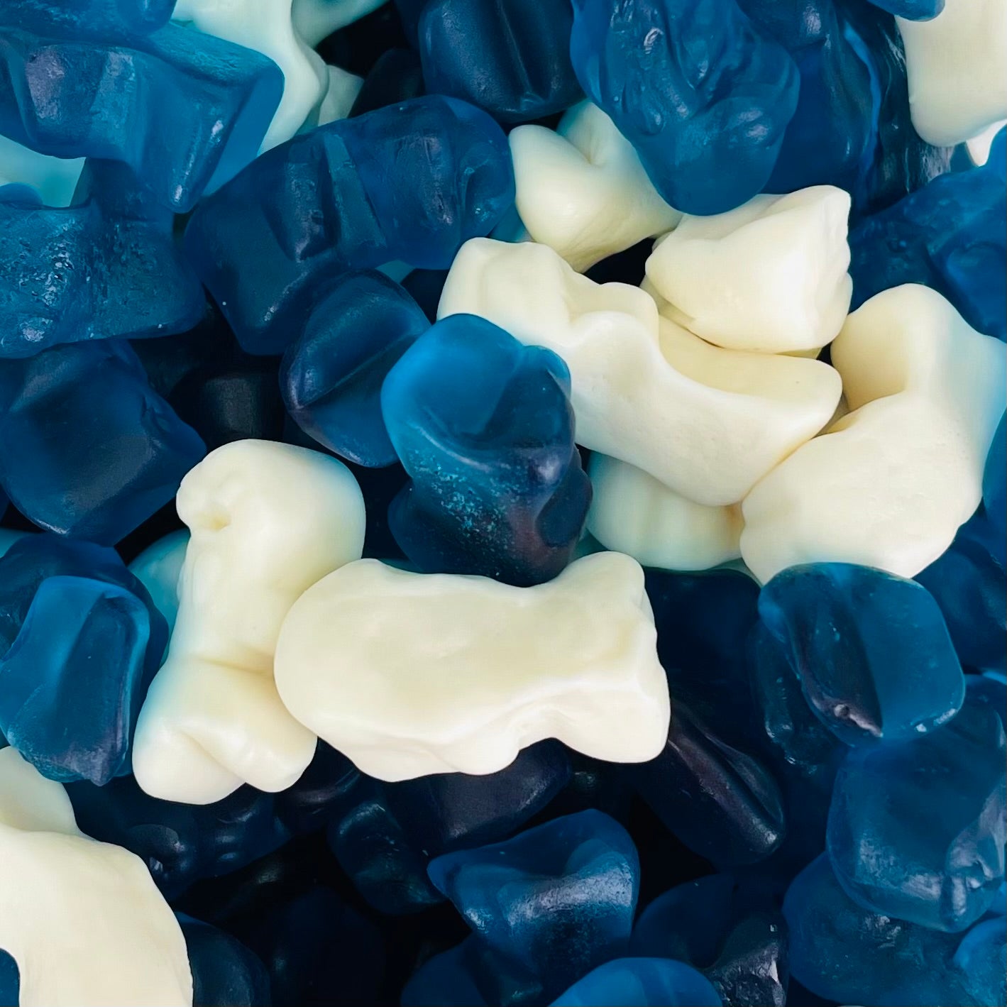 Blue and white gummy sweets shaped like a small dolphin
