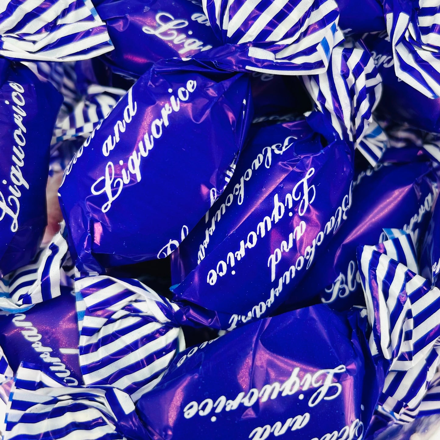Individually wrapped purple hard boiled blackcurrant and liquorice sweets