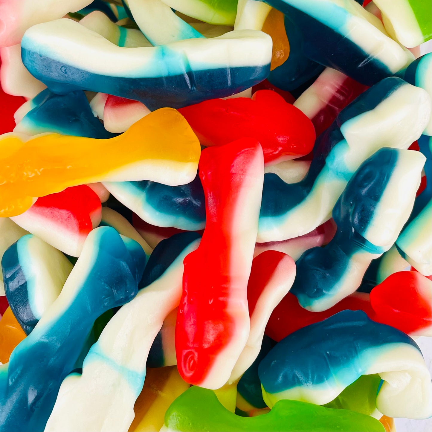 Gummy sweets in the shape of sharks in red, blue, green and yellow colours