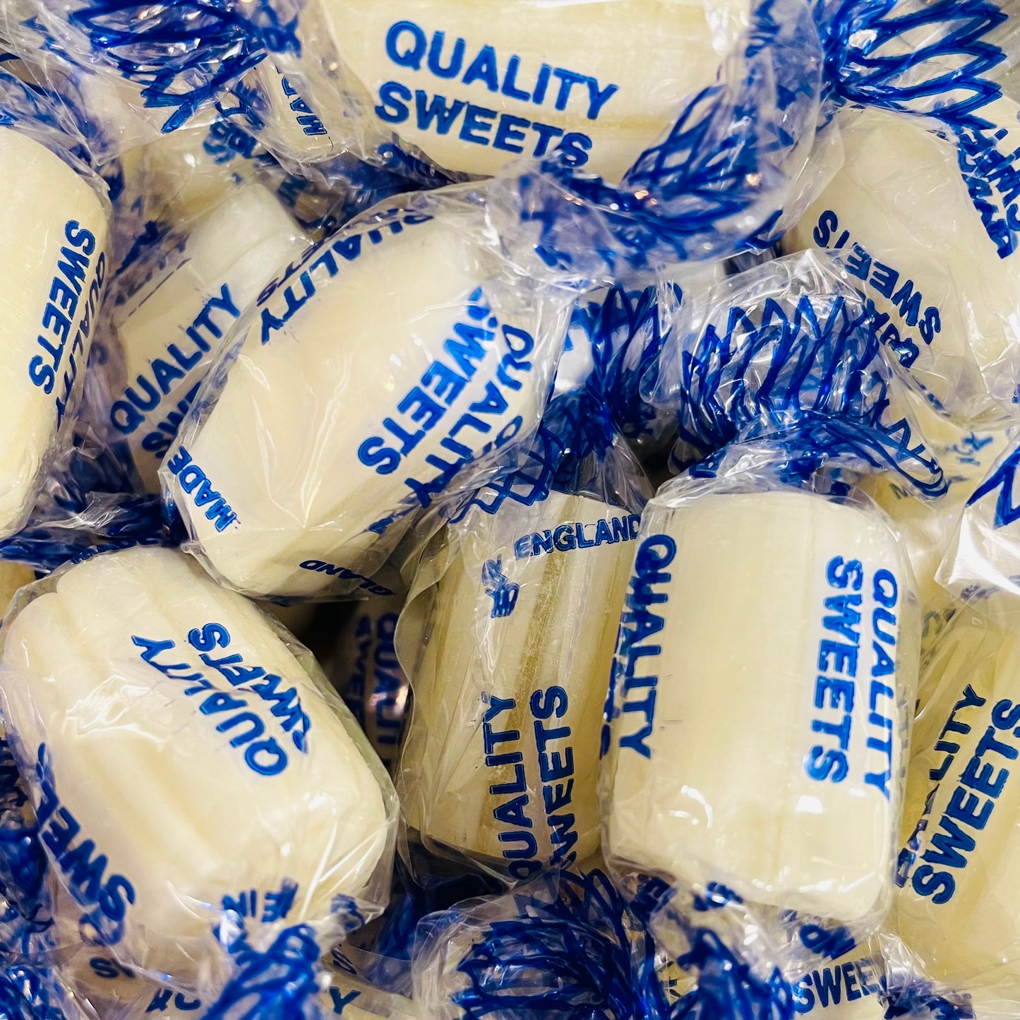 Pile of mint rock sweets in individually wrapped packaging 